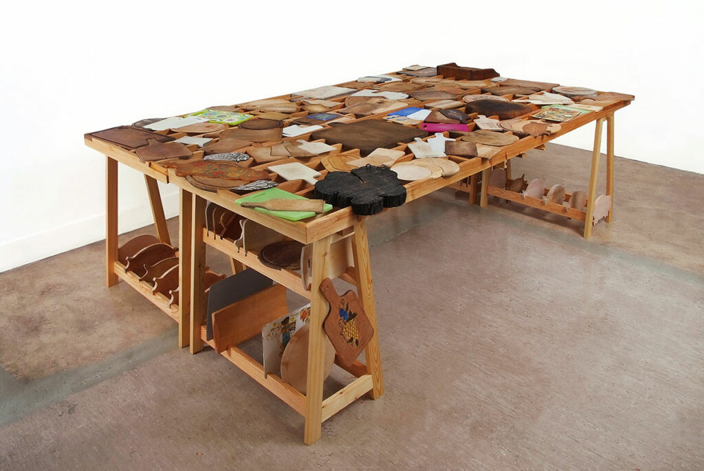 barbara caveng Table-Sculpture 'plantse à dékopȃ' | cup-board-table | Leytron 2012 
je 300 x 85 x 83cm | ca. 120 Cupboards | ©Julie Langenegger 